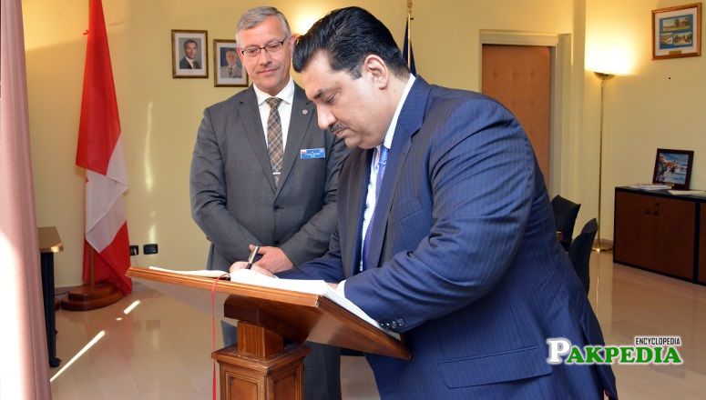 Khurram dastgir while signing NDC guest book