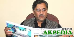 Muhammad Pervaiz Malik read a News Paper